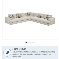White sectional with ottoman from Rooms to Go