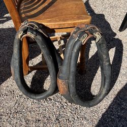 A pair of vintage leather and padded horse collars.