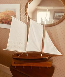 Wooden sailboat & stand. Muslin sails. 36” high; 35” across.