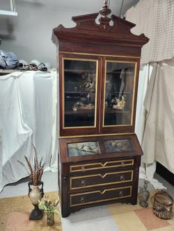 Antique Secretary Desk with book case and ornamental crown molding.