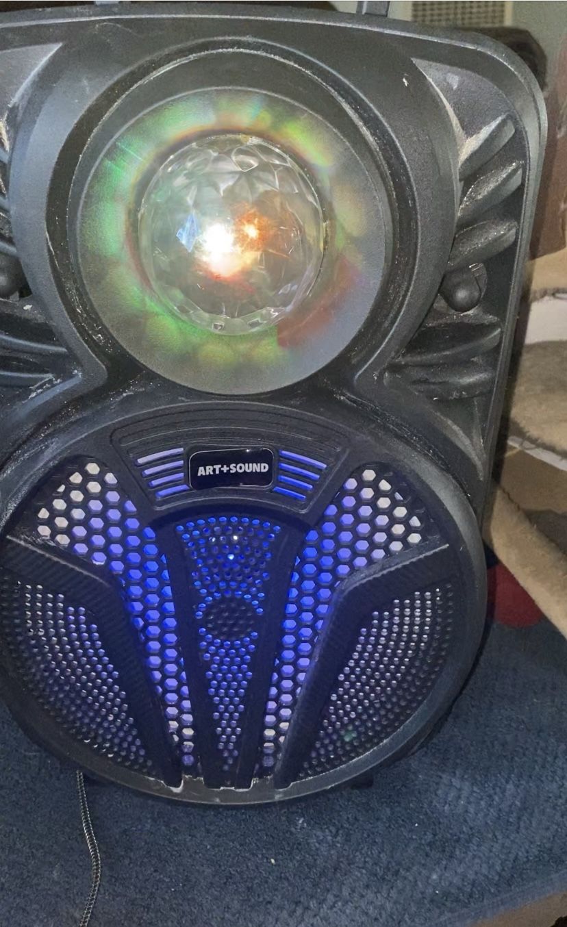 Speaker with the disco ball and the lights light up top and bottom about a foot and a half tall