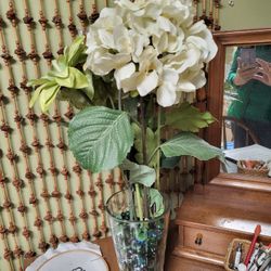 Vase with artificial flowers and glass pebbles