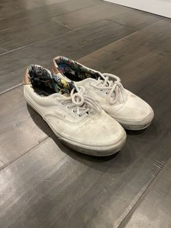 Laced White Vans with pattern on the inside.