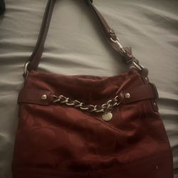 Cranberry colored Coach purse.