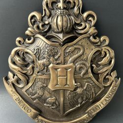 The Harry Potter Hogwarts School Crest WALL ART Wall Hanging is a collectible piece inspired by the iconic Hogwarts School from the Harry Potter fran