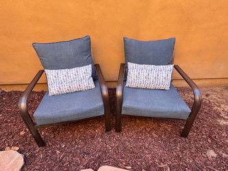 Two patio chairs, metal with cushions