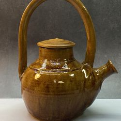 Gorgeous clay teapot, likely a Yixing clay teapot, known for its use in traditional Chinese tea ceremonies.  typically made from glazed clay, specific