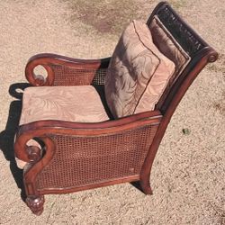 Large wooden accent chair with cushions. Solid and comfortable, just takes up more space than I need.