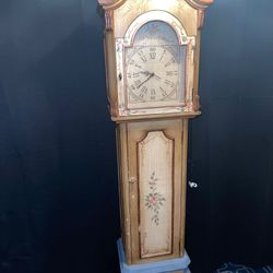 This is a custom hand painted and colored Pulaski model floor clock, a type of grandfather clock. The clock features a decorative floral design and a 