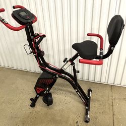 Exercise bike with backrest and arm supports
