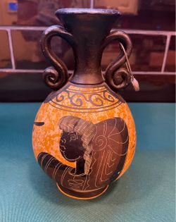 Beautiful vintage handmade ceramic Amphora vase of Greek female figure on textured background