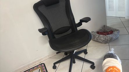 Title: Black Ergonomic Mesh Office Chair with Adjustable Arms