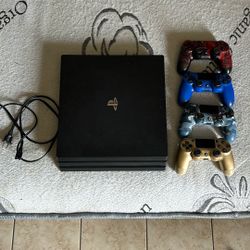 PS4 PRO w/ GAMES & CONTROLLERS