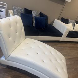 L shape couch, with white chair and White fire place.