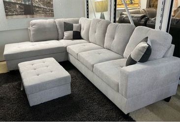 Gray linen sectional couch and storage ottoman