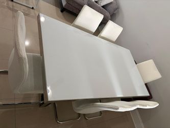 Beautiful table with 6 chairs. Chairs have tear and wear, but are beautifully covered.