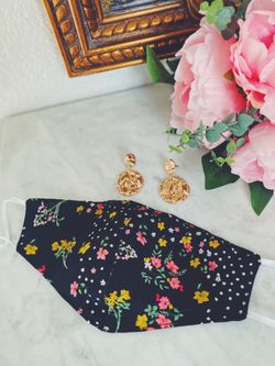 Black floral prints face mask with gold earrings