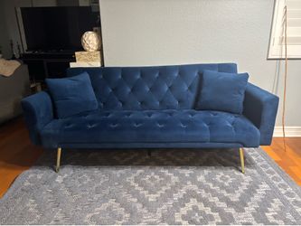 Sofá cama de terciopelo azul usado