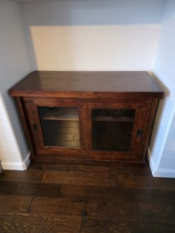 Wood Cabinet With Sliding Glass Doors.