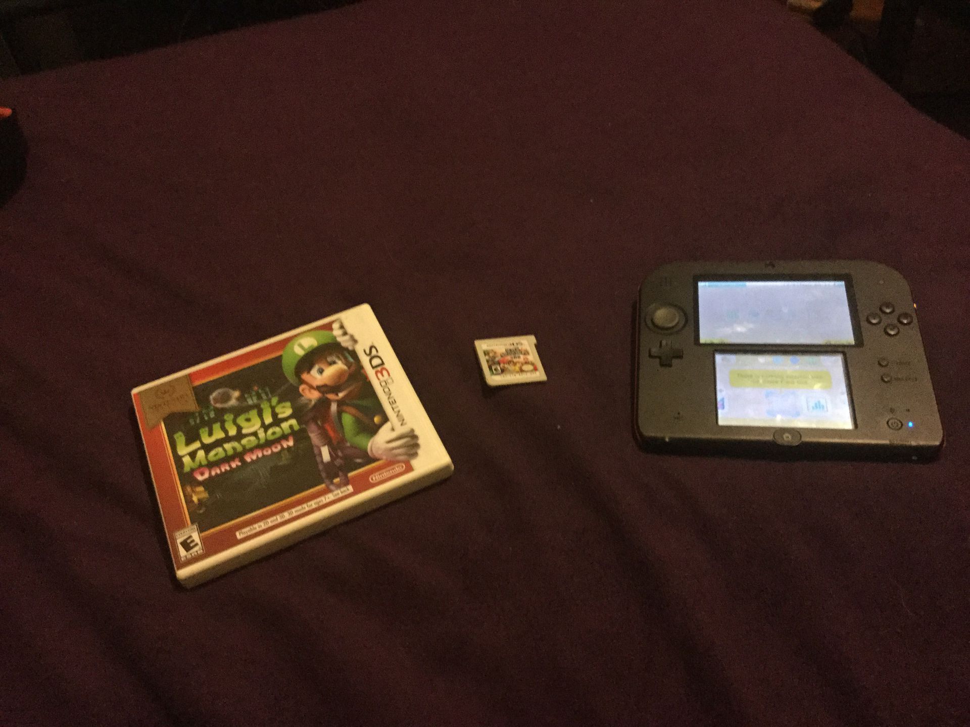 Nintendo 2ds with super smash bro’s and luigis mansion dark moon/ no 4 gb SD card with charger