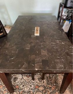 Granite/Marble table with four chairs.