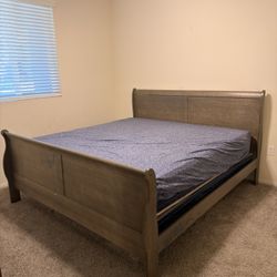 King bedroom set in good condition. Includes king bed frame (headboard, footboard, rails), dresser with mirror, and 5-drawer chest.