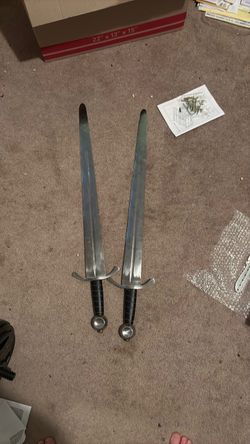 Two steel training swords