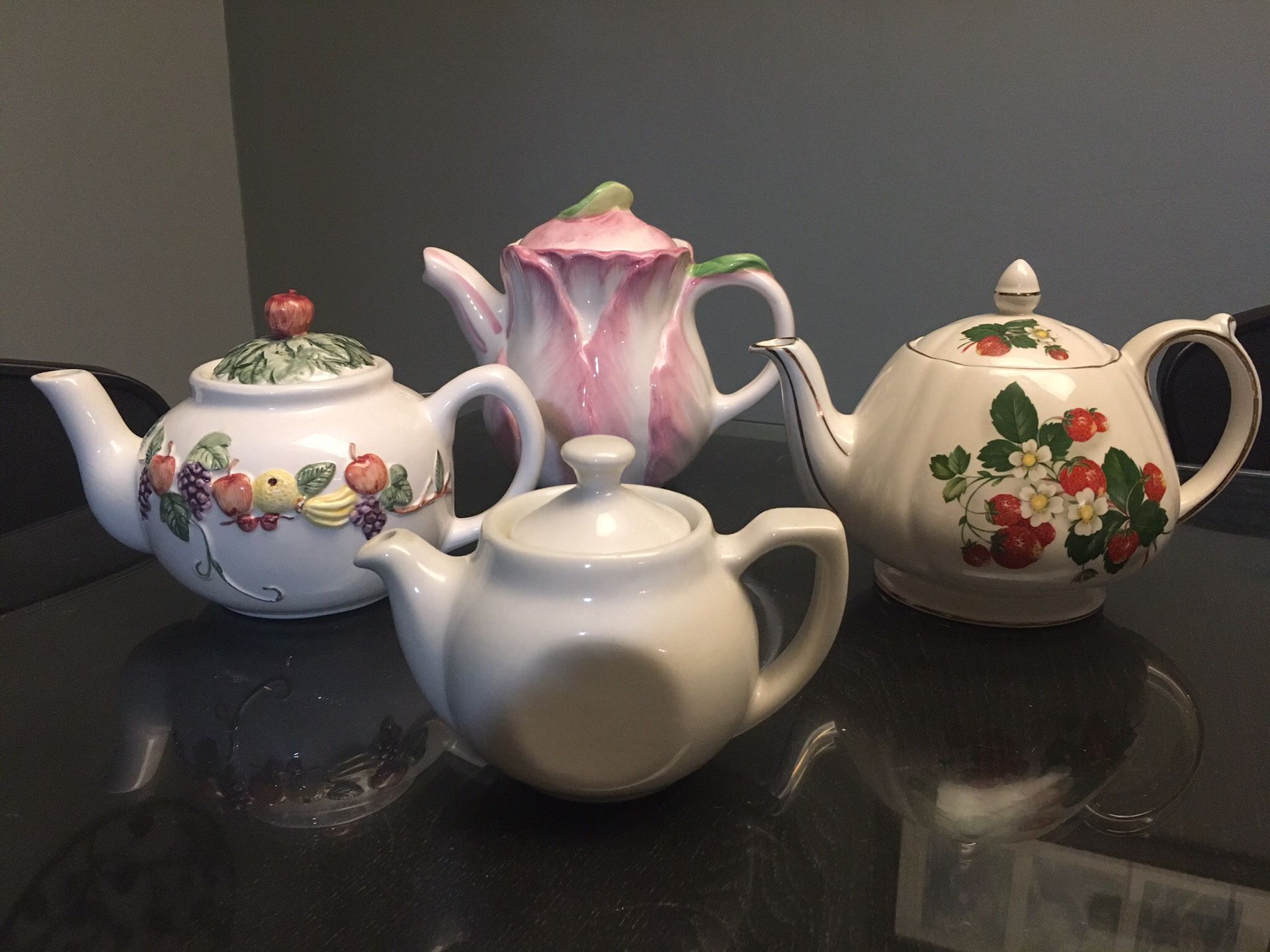 Vintage assorted tea pots, tea cups, tea plates, and pitchers