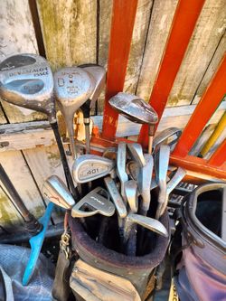 TWO GOLF BAGS WITH 12 CLUBS  PLENTY OF BALLS