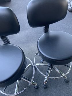 Two Black Swivel Chairs.