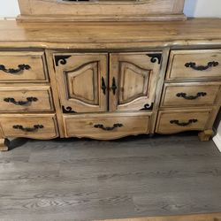 Cast iron king size bed frame with matching dresser and mirror.
