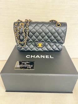 New authentic Chanel with box …Black caviar leather Chanel Classic Double Flap bag with gold-tone CC turn-lock closure and woven chain-leather strap. 