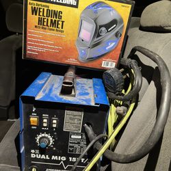 Welder with helmet apron and gloves