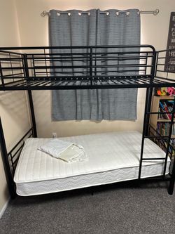 Bunk bed with mattress, sheets, and cover