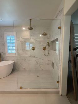 Frameless Glass Shower Enclosure with Gold Hardware