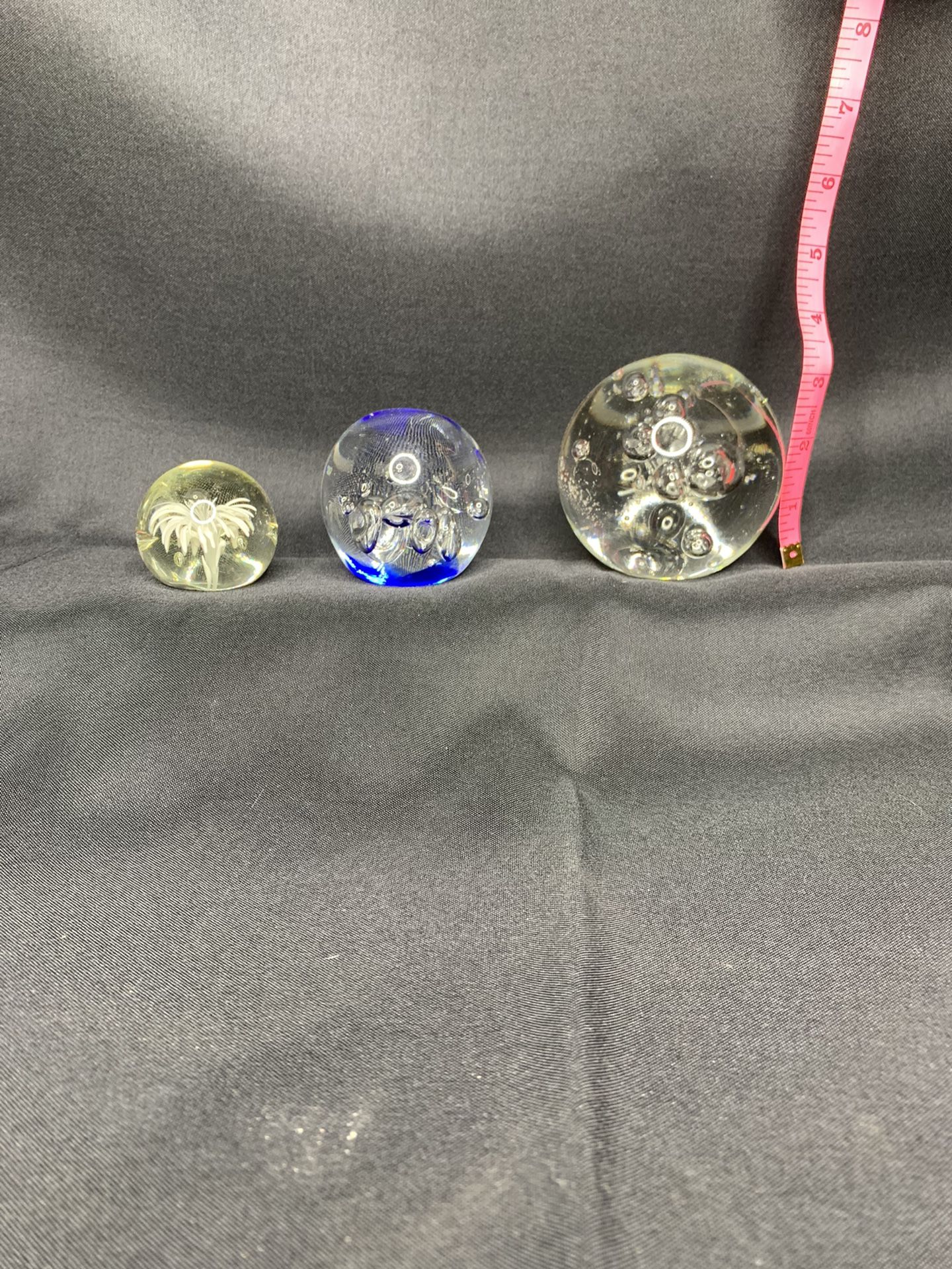 Three different size glass balls with bubbles in ball