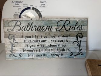 Small wood sign in the bathroom