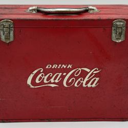 Vintage red metal Coca-Cola airline cooler with iconic branding.