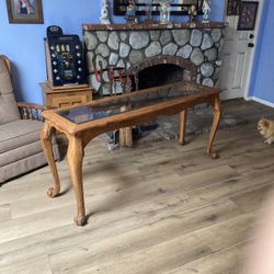 Wood entry table with glass top.