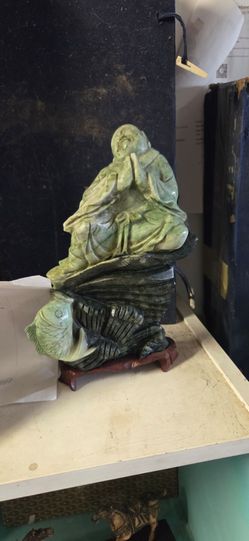 Jade greenstone Buddha in prayer hand carved