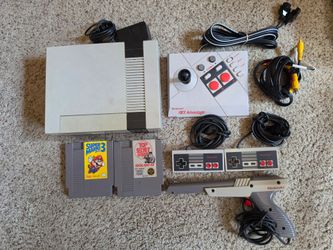 Nintendo NES model nes-001 comes with two controllers, NES advantage controller, light gun, 2 games