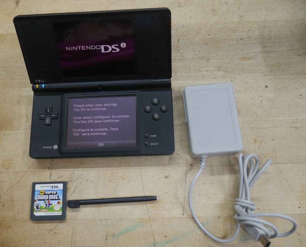  Nintendo DSi Black With Stylus Game Super Marion Bros Charger - Tested and Works used. tested. in a good working order. factory reset was done.  