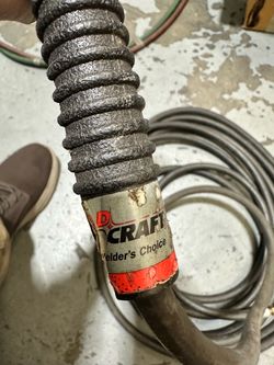 Tig torch and oxygen hose.