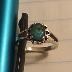 1950 Baby vintage or antique-style sterling silver ring with a round, cabochon-cut green gemstone. 