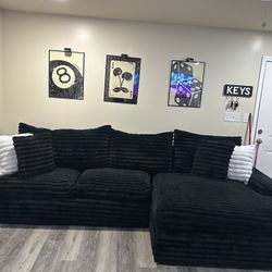 Sectional  Black With Black And White Pillows 