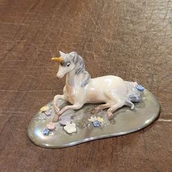Vintage 90s Retired Hagen Renaker Lying Unicorn On Flowery Base.
Manufacturer: Hagen-Renaker, a California-based company known for 
ceramic animal fig
