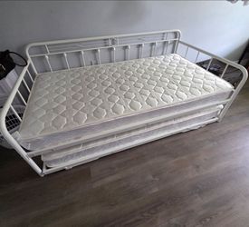 White metal bed with trundle