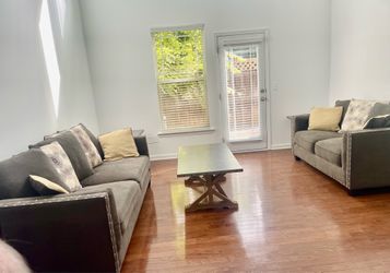 Dark brown sofa and loveseat set with nailheads trim