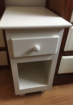 White drawer used for storage, bed side desk