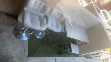 Table with two stools same color as the table